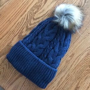 Knitted hat with fold up cuff and faux fur Pom.